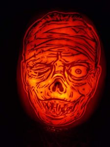 zombie face carved on a pumpkin